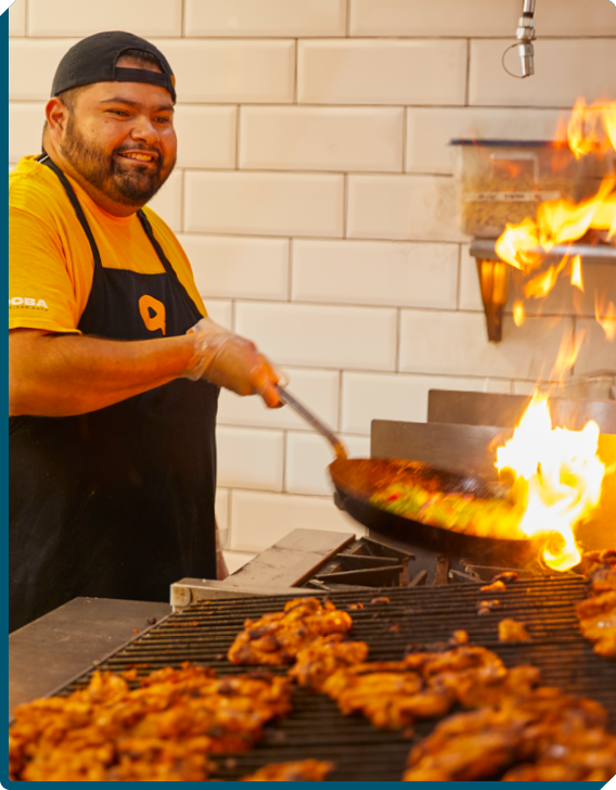 QDOBA Employee Cooking Flavorful Fresh Food